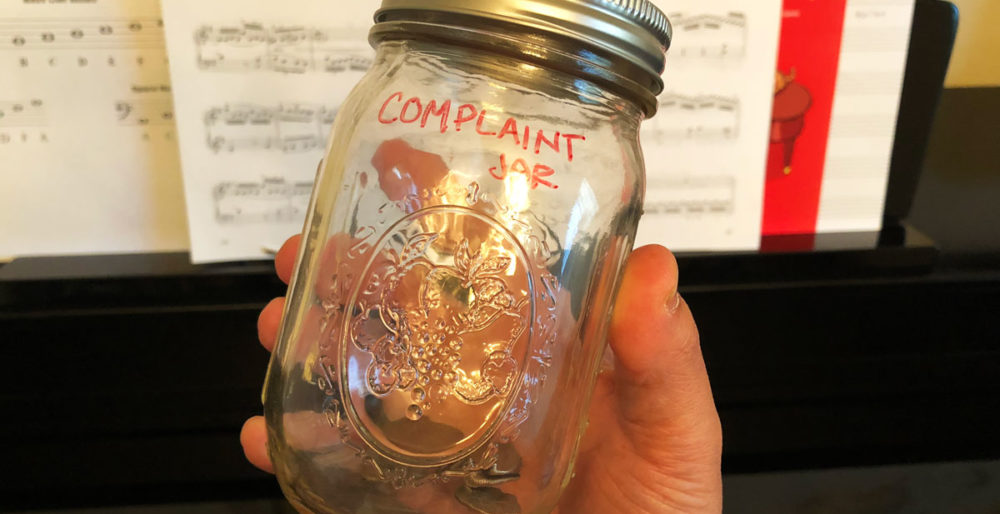 The Complaint Jar with Quarters in it.
